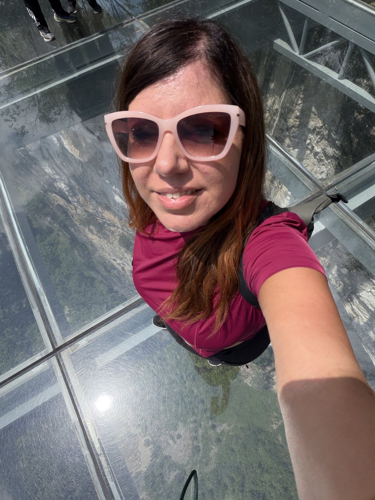 Linda on a glass-floored sky platform above the Wulong karst