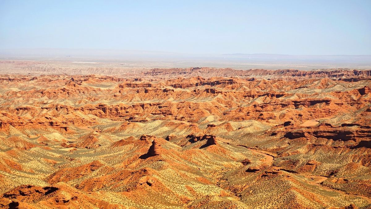 Red sandstone ridges of the Pingshan Grand Canyon stretching to the horizon, Zhangye