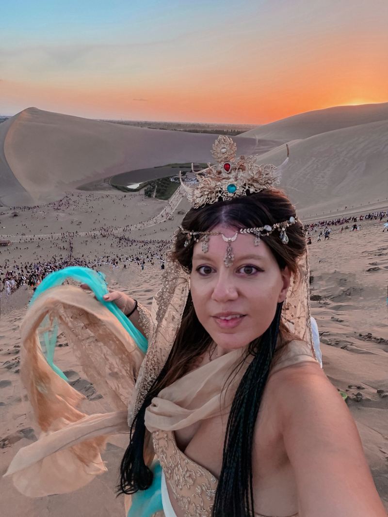 Selfie in a golden hanfu headdress on the Mingsha Shan dunes at sunset