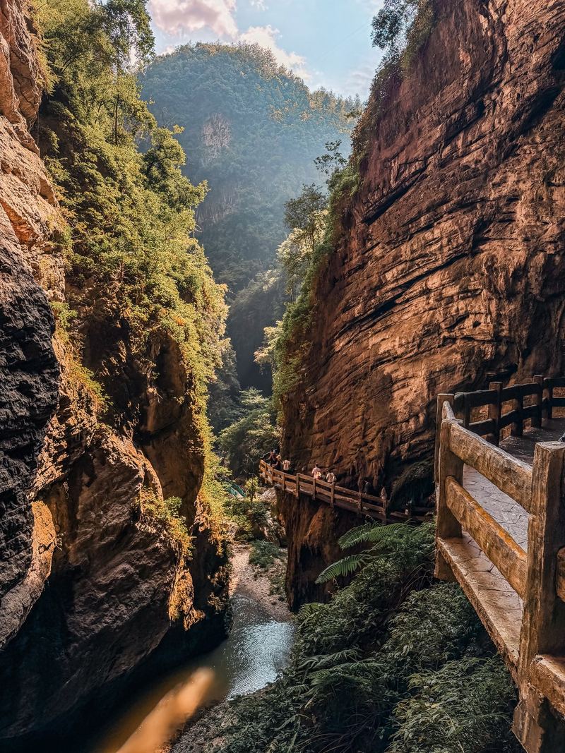 Sunlight falling into Longshuixia gorge, with a railing walkway on the cliff