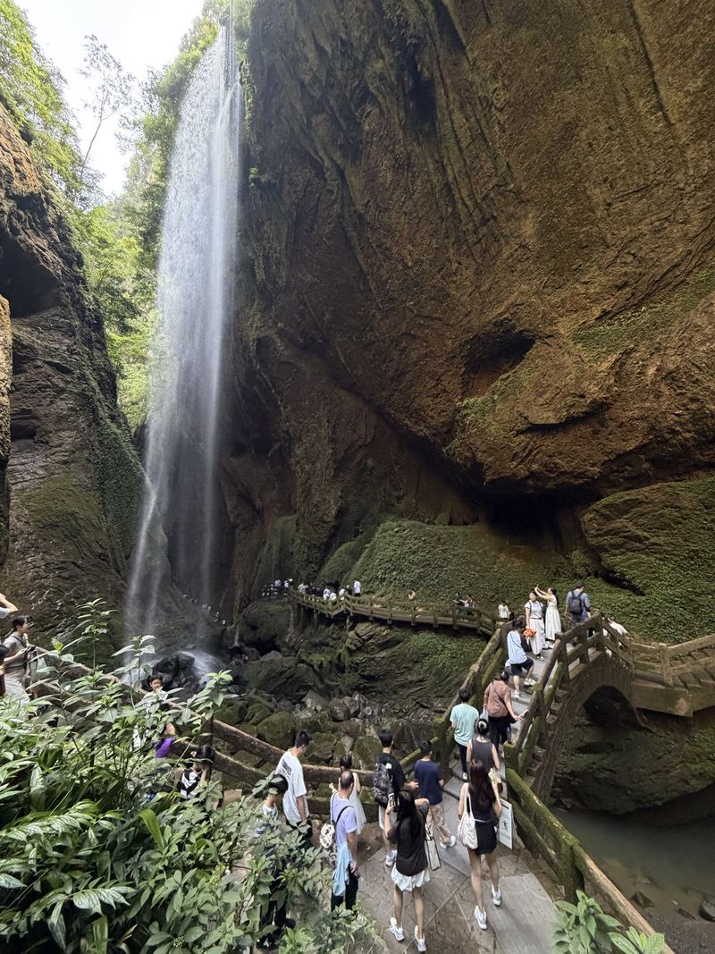 A tall waterfall pouring down the cliff at Longshuixia gorge, Wulong