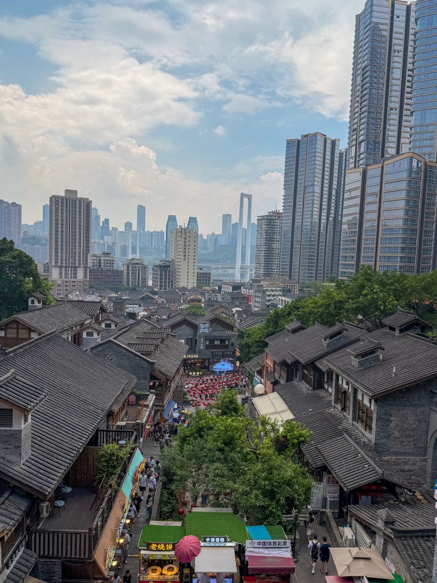 Old tiled roofs of Eighteen Stairs with Chongqing skyscrapers behind