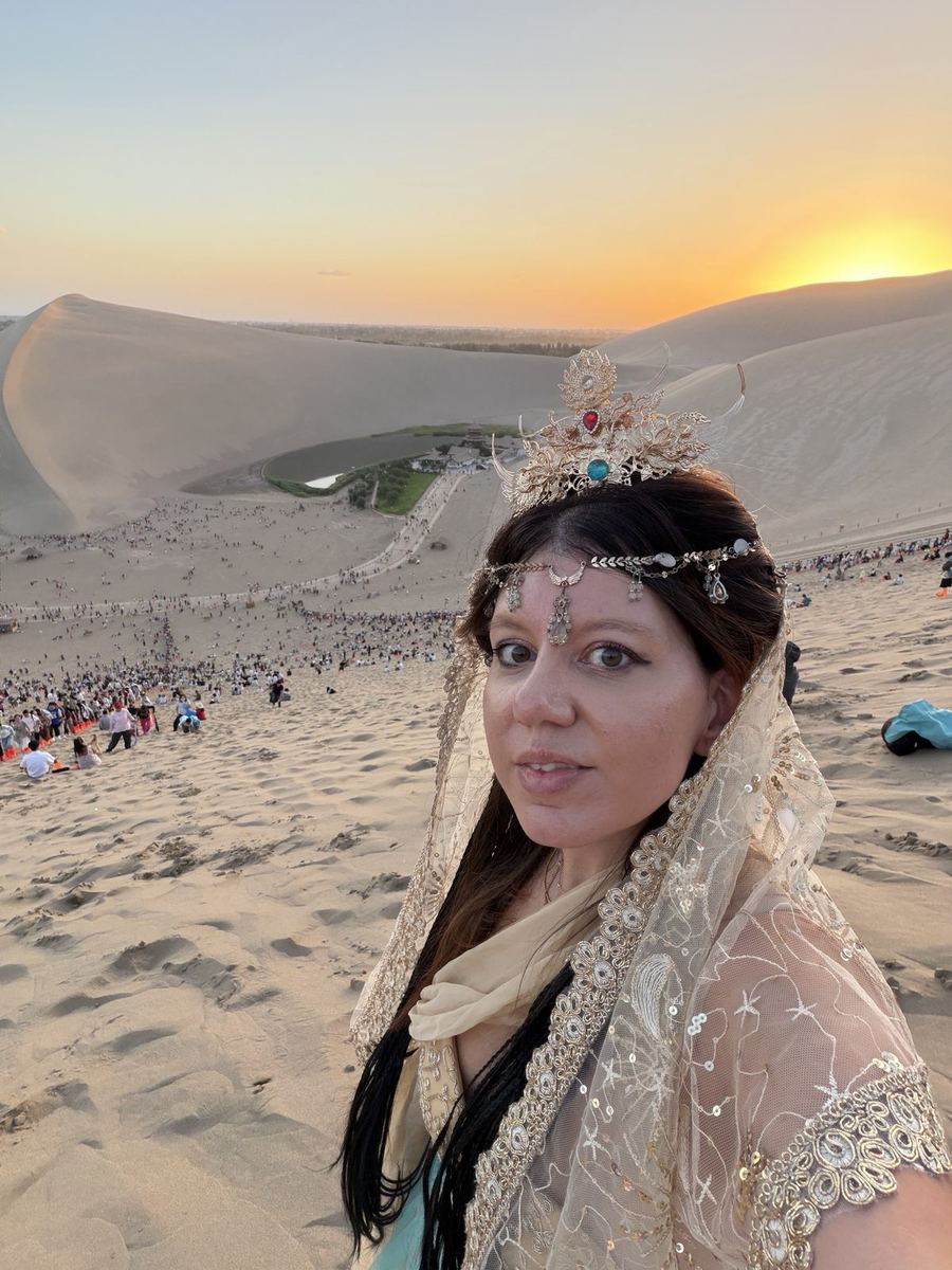 Linda in a Dunhuang costume at sunset on the Mingsha Shan dunes above Crescent Lake