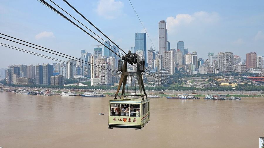 A Yangtze River Cableway cabin crossing the river in front of the Yuzhong skyline
