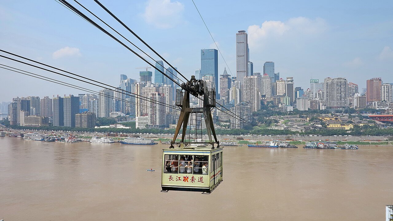 A Yangtze River Cableway cabin crossing the river in front of the Yuzhong skyline