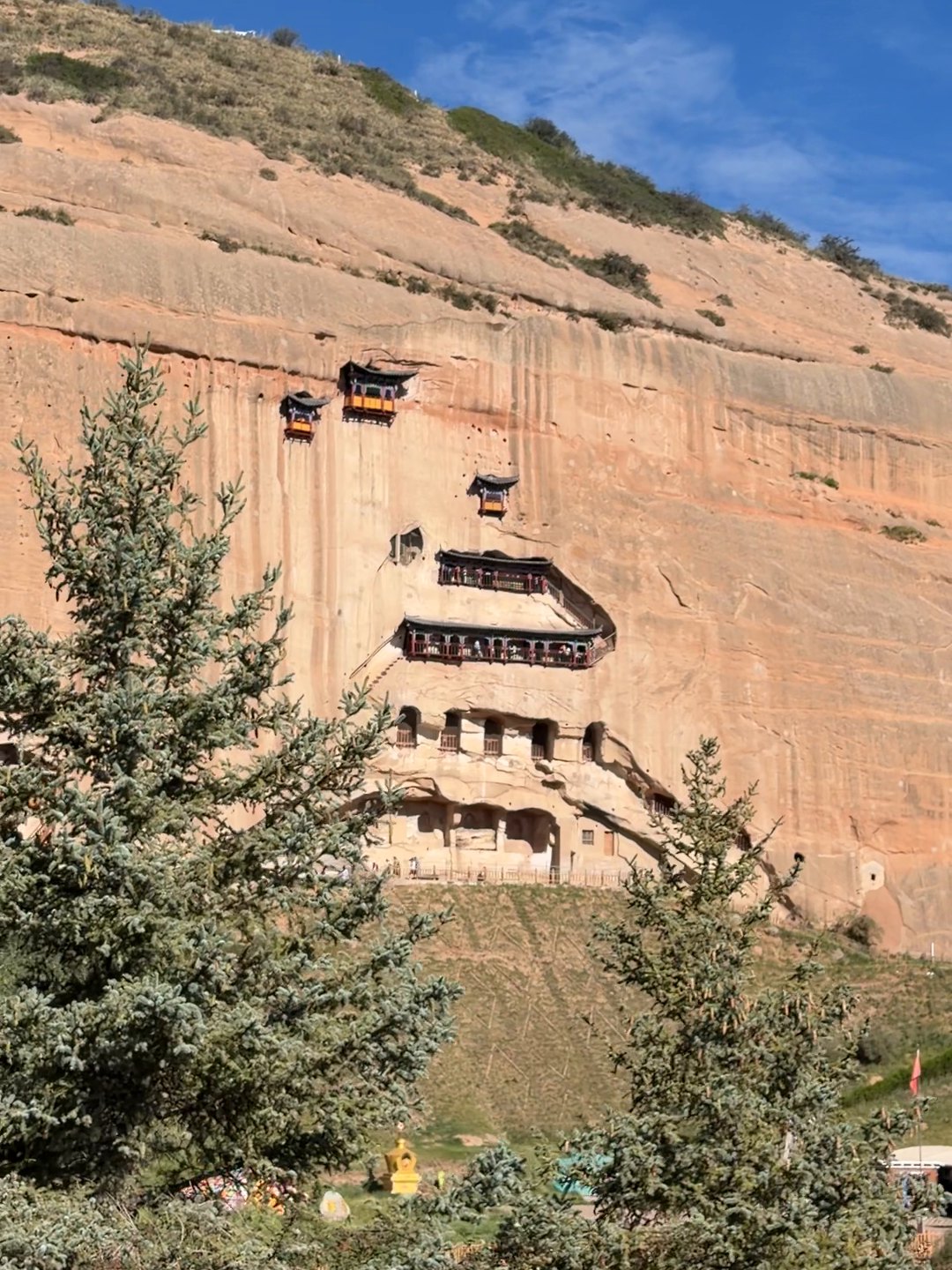 The Thirty-Three Heavens cliff at Mati Temple, with pavilions stacked up the rock face above the pine trees